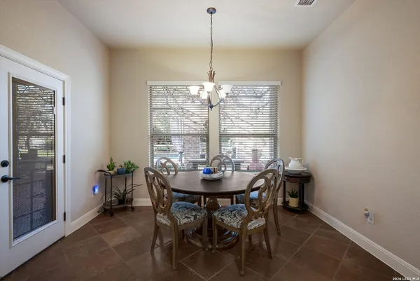 a dining room with furniture a chandelier and window
