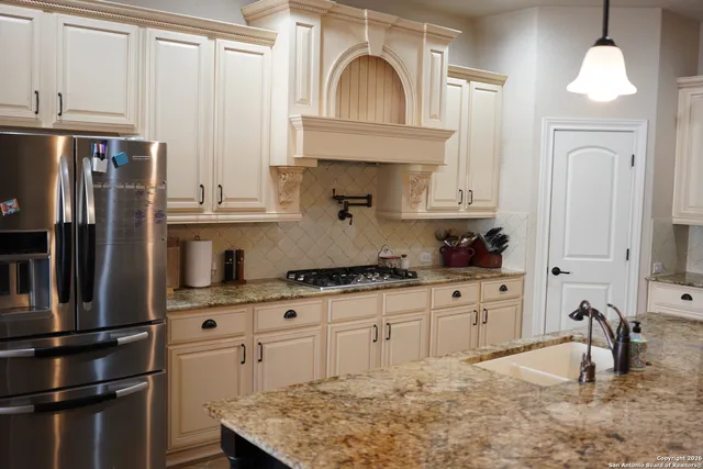 a kitchen with stainless steel appliances a sink stove and refrigerator