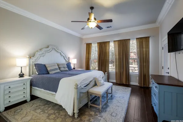 a spacious bedroom with a large bed and a chandelier