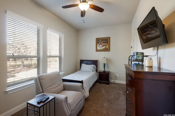 a bedroom with a bed window and a flat screen tv