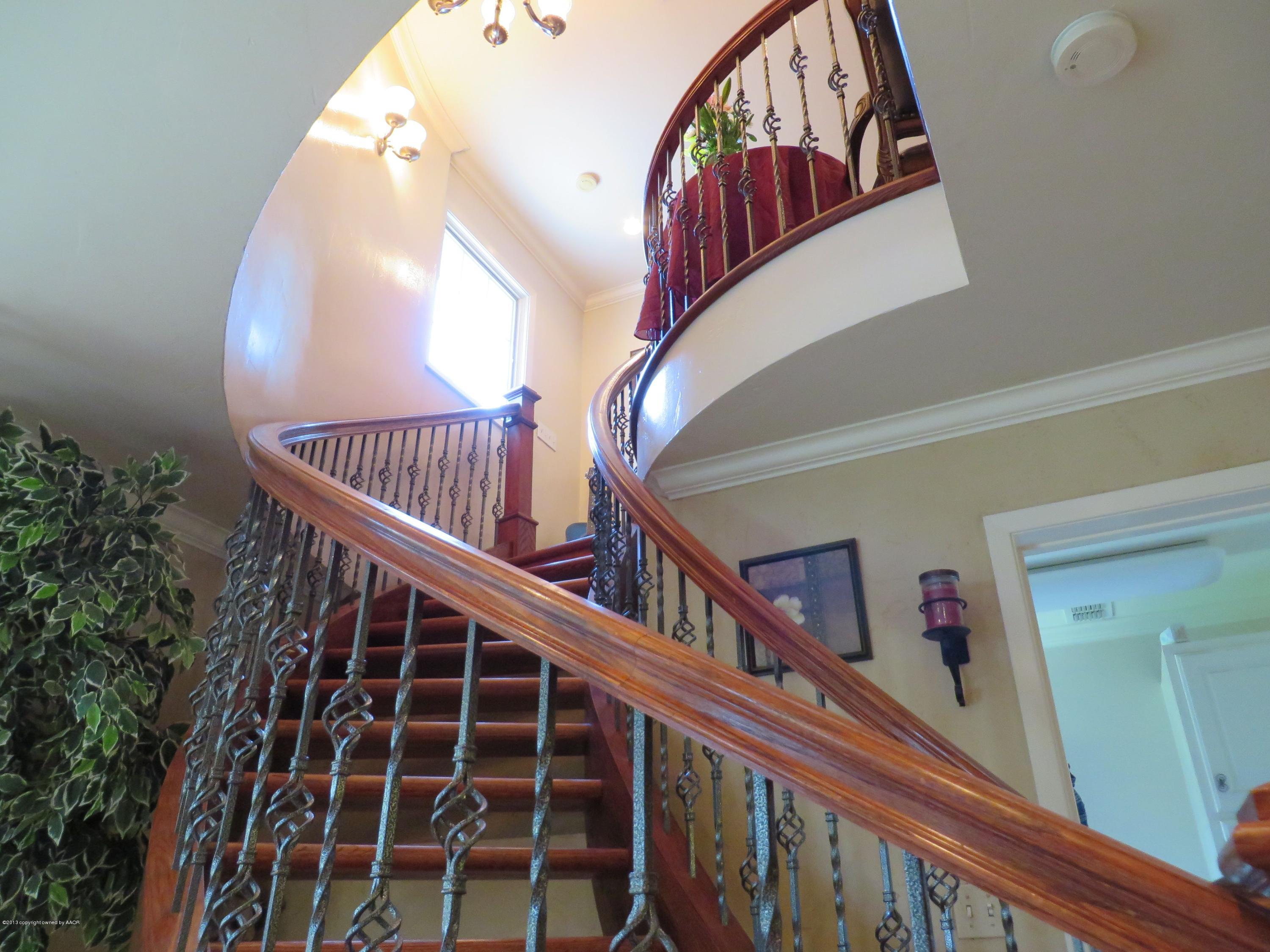 6713 Jameson Road Amarillo, TX 79106 - Photo 11 of 23 a view of staircase with railing and a chandelier