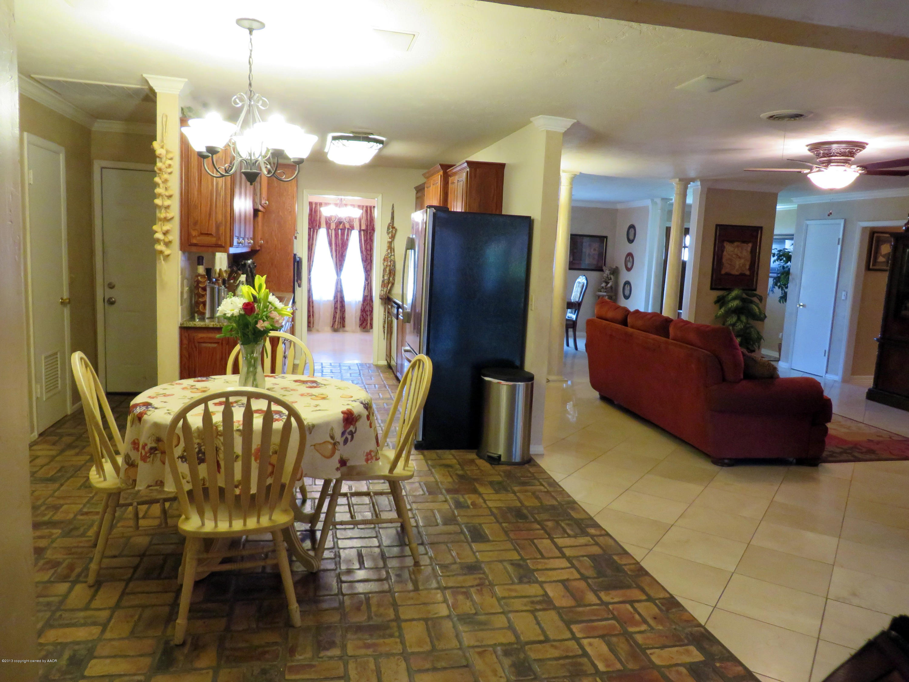 6713 Jameson Road Amarillo, TX 79106 - Photo 6 of 23 a view of a dining room with furniture and chandelier