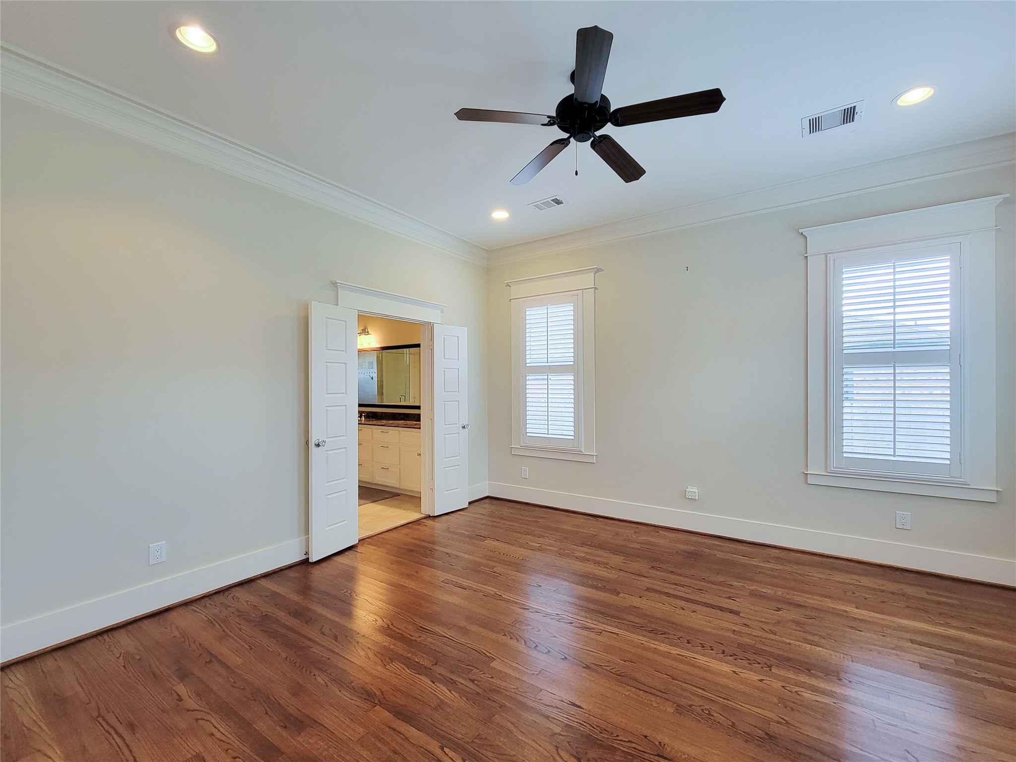 1140 West Cottage Street Houston, TX 77009 - Photo 26 of 37 a view of a big room with wooden floor a ceiling fan and windows