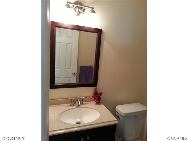 6591 Balsam Road Richmond, VA 23225 - Photo 16 of 24 a bathroom with a toilet sink and mirror