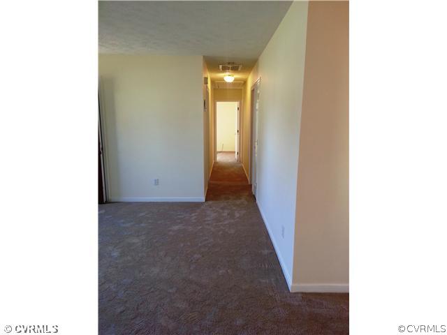 6591 Balsam Road Richmond, VA 23225 - Photo 23 of 24 a view of a hallway with wooden floor