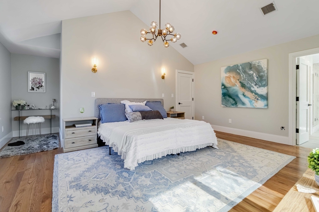 3 Cedar Street Newton, MA 02459 - Photo 17 of 33 a bedroom with a large bed and a chandelier