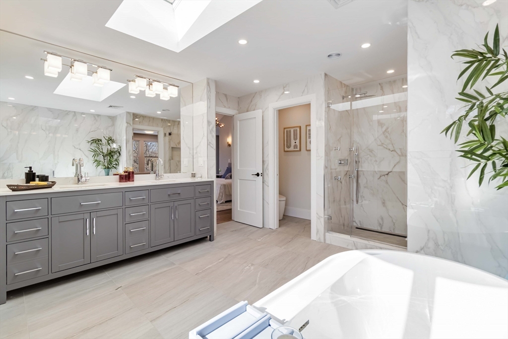 3 Cedar Street Newton, MA 02459 - Photo 19 of 33 a spacious bathroom with a double vanity sink shower and a mirror