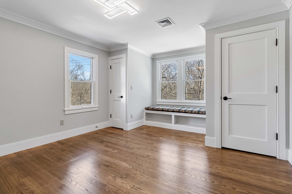3 Cedar Street Newton, MA 02459 - Photo 21 of 33 an empty room with wooden floor and windows