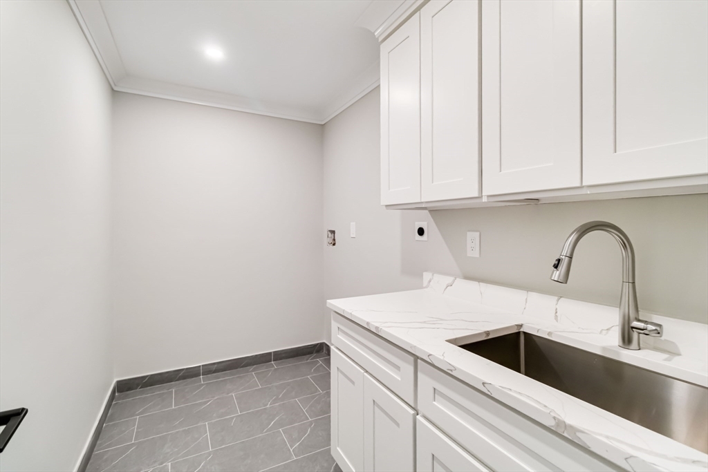 3 Cedar Street Newton, MA 02459 - Photo 23 of 33 a kitchen with a sink and cabinets