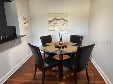 a view of a dining room with furniture and wooden floor