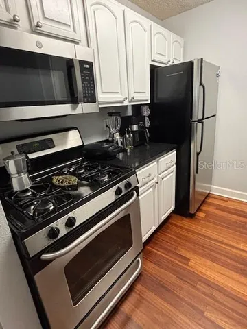 a kitchen with stainless steel appliances and white cabinets