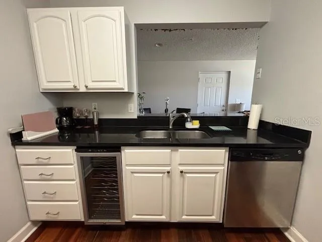 a kitchen with granite countertop a sink and cabinets