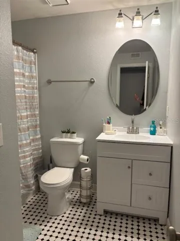 a bathroom with a sink toilet and a mirror