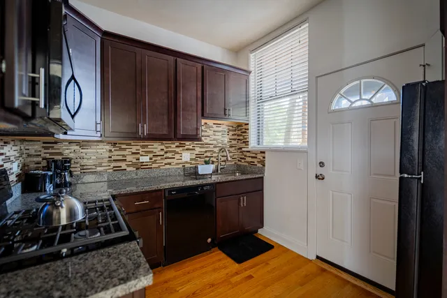 a kitchen with wooden cabinets and a stove top oven