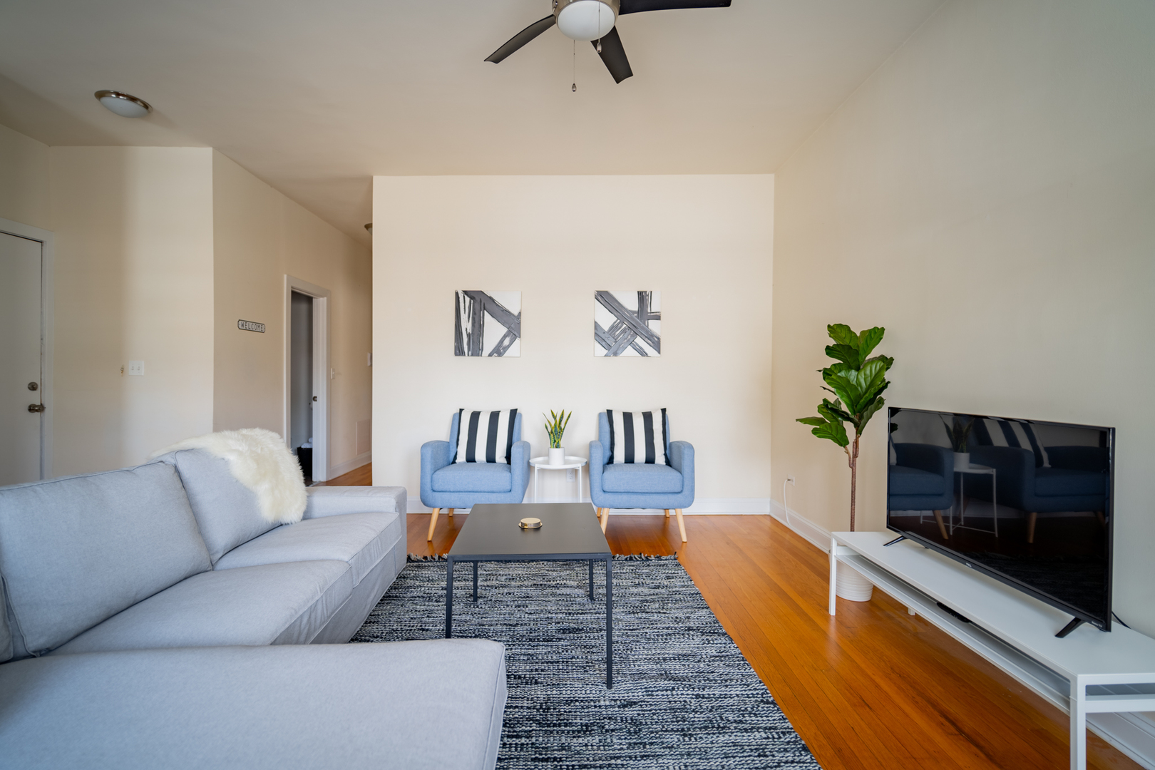 2989 North Lawndale Avenue, Unit 1 Chicago, IL 60618 - Photo 3 of 18 a living room with furniture and a flat screen tv