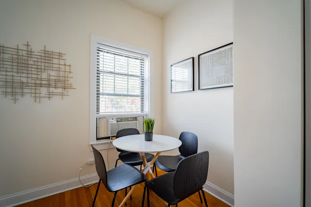 a view of a dining room with furniture and window