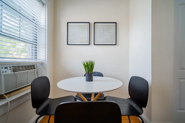 a dining room with furniture and wooden floor