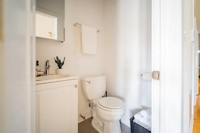 a bathroom with a sink a toilet and a mirror