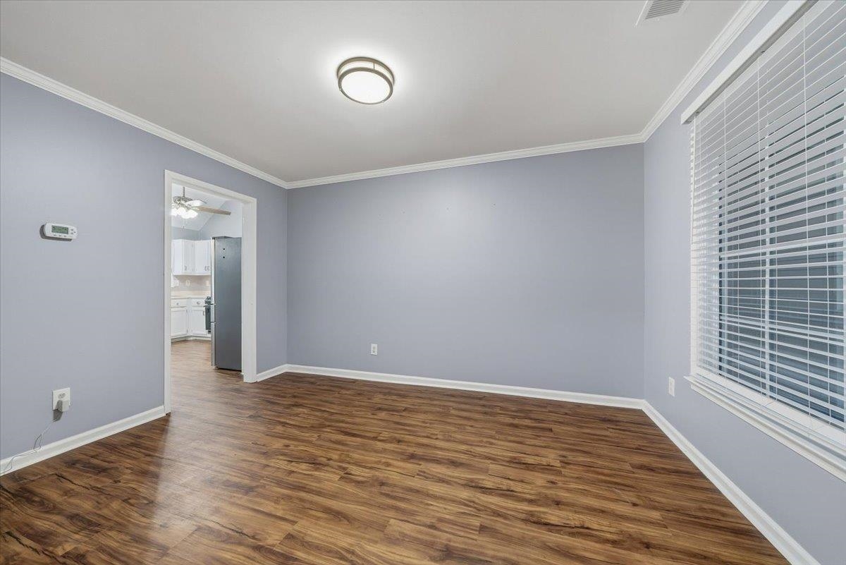 406 Ashley Drive Collierville, TN 38017 - Photo 5 of 20 a view of an empty room with wooden floor and a window