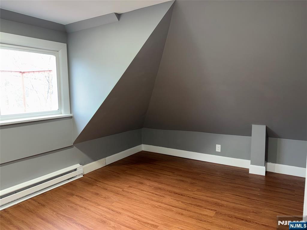 178 Berry Street Hackensack, NJ 07601 - Photo 19 of 22 a view of an empty room with wooden floor and a window