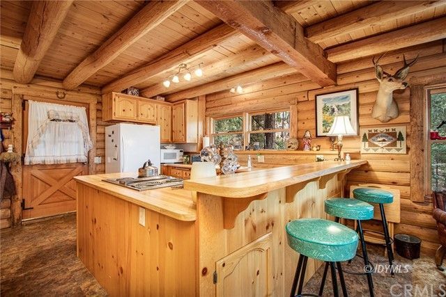 25121 Pine Cove Road Idyllwild, CA 92549 - Photo 3 of 10 a kitchen with stainless steel appliances kitchen island granite countertop a sink and cabinets
