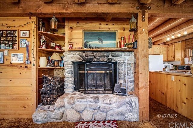 25121 Pine Cove Road Idyllwild, CA 92549 - Photo 4 of 10 a view of living room with a fireplace