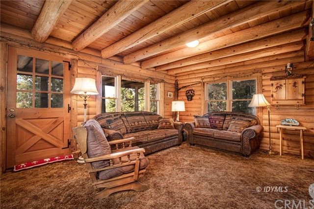 25121 Pine Cove Road Idyllwild, CA 92549 - Photo 6 of 10 a living room with furniture a wooden floor and next to a window