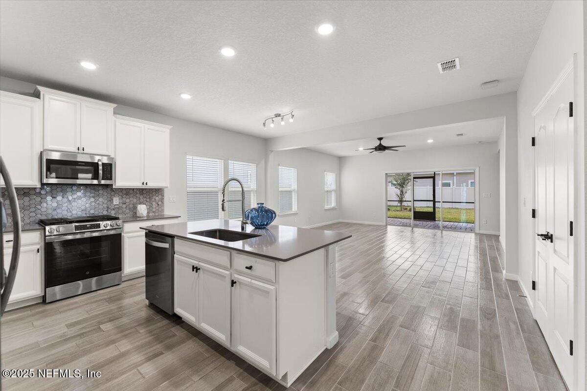 24 Purus Way St. Johns, FL 32259 - Photo 11 of 37 a kitchen with stainless steel appliances granite countertop a stove and a sink