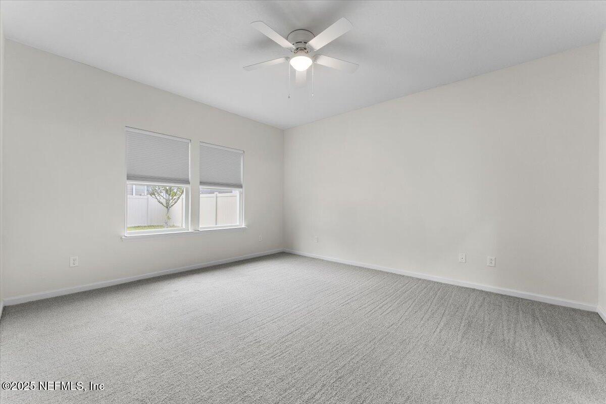 24 Purus Way St. Johns, FL 32259 - Photo 16 of 37 an empty room with a window and a ceiling fan
