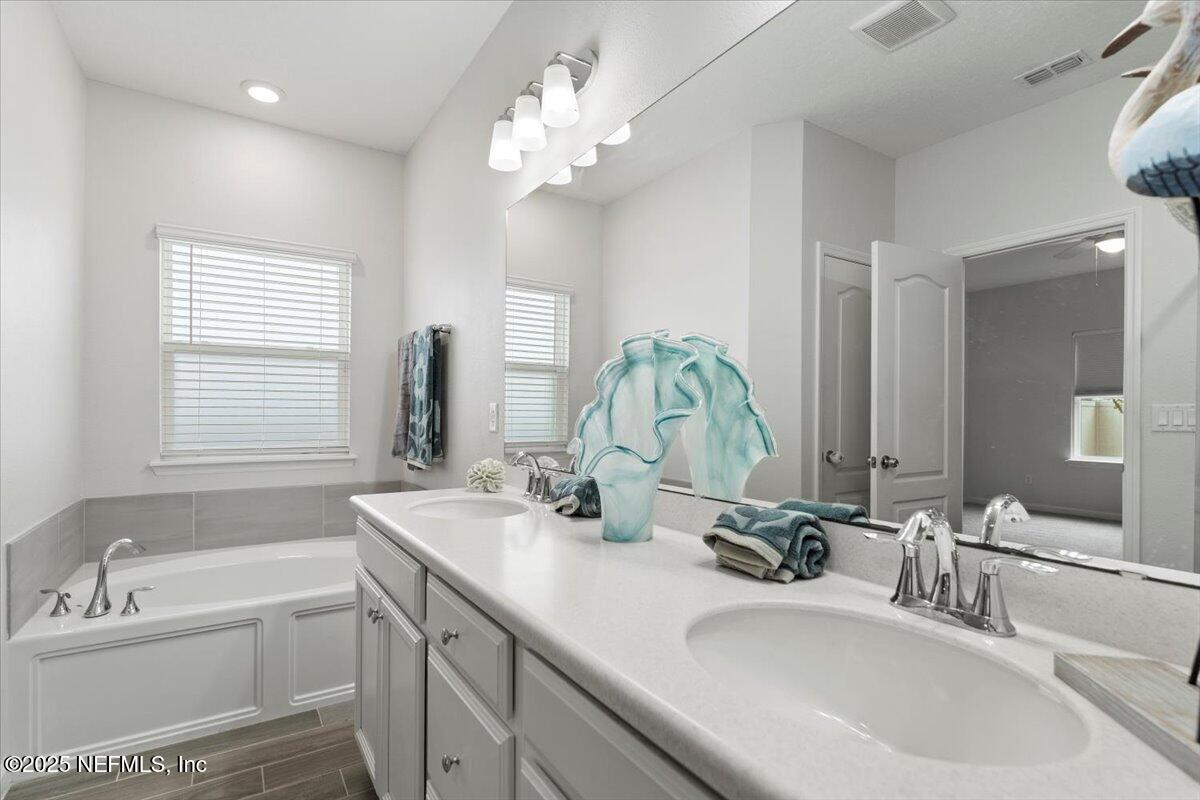 24 Purus Way St. Johns, FL 32259 - Photo 17 of 37 a bathroom with a double vanity sink window and a mirror