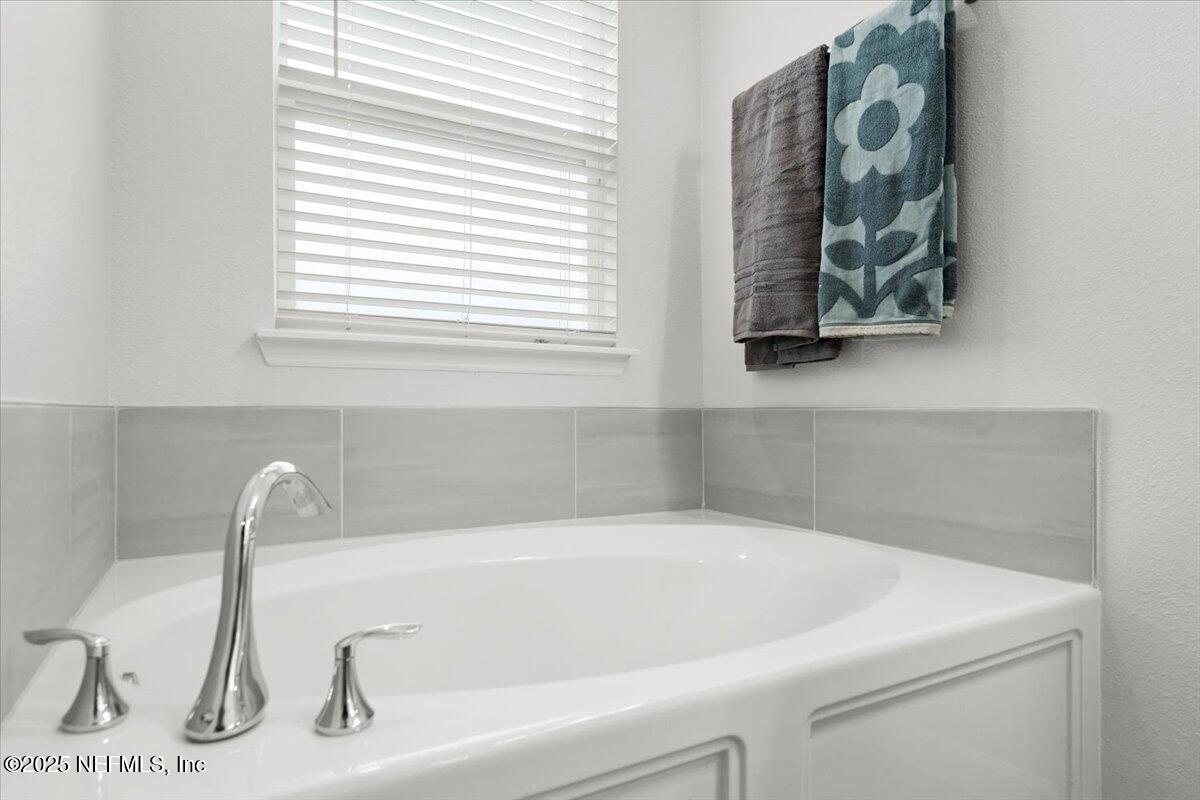 24 Purus Way St. Johns, FL 32259 - Photo 18 of 37 a white bath tub sitting next to a window