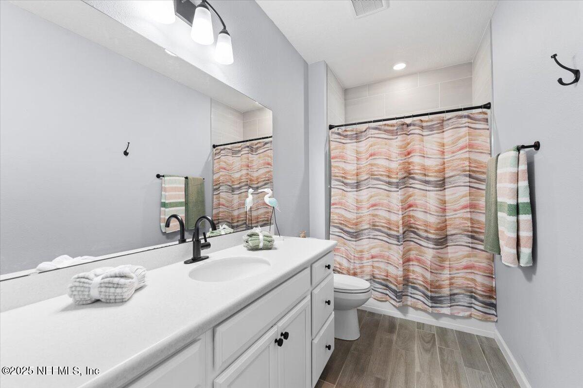 24 Purus Way St. Johns, FL 32259 - Photo 25 of 37 a bathroom with a sink a toilet and shower curtain