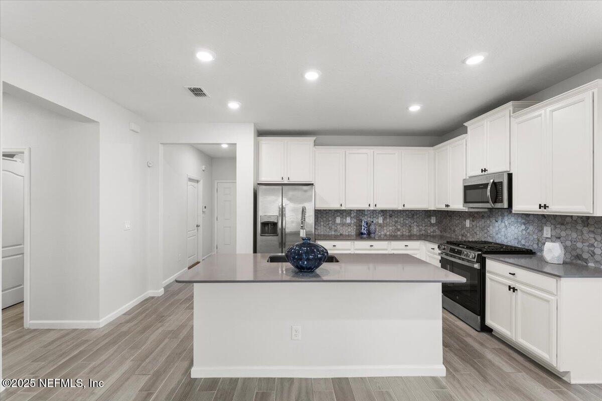 24 Purus Way St. Johns, FL 32259 - Photo 7 of 37 a kitchen with stainless steel appliances a sink stove and refrigerator
