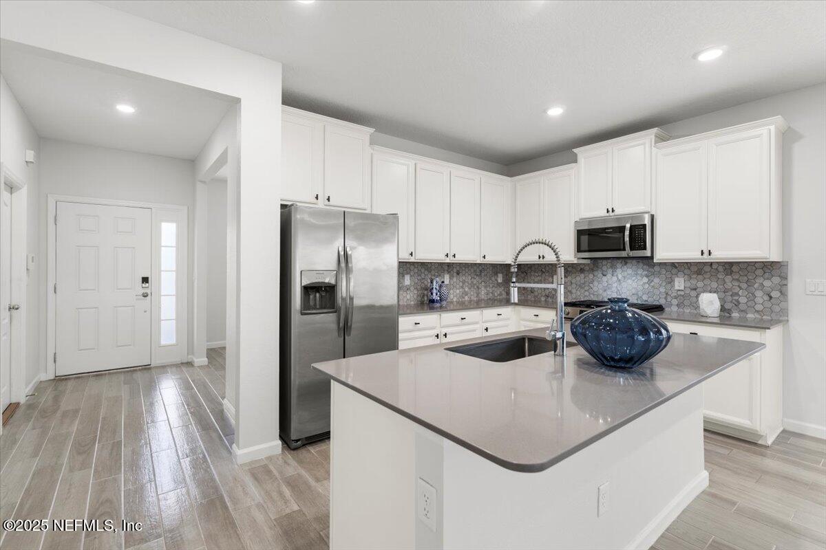 24 Purus Way St. Johns, FL 32259 - Photo 10 of 37 a kitchen with sink a refrigerator and cabinets