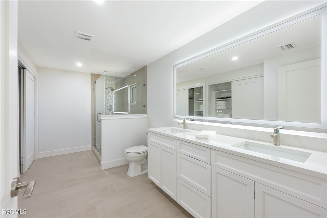 707 Durion Court Sanibel, FL 33957 - Photo 16 of 31 a bathroom with a toilet sink and mirror