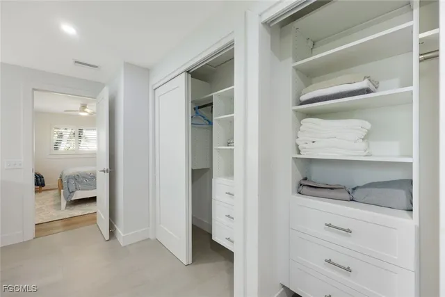 a bedroom with two beds and a large window