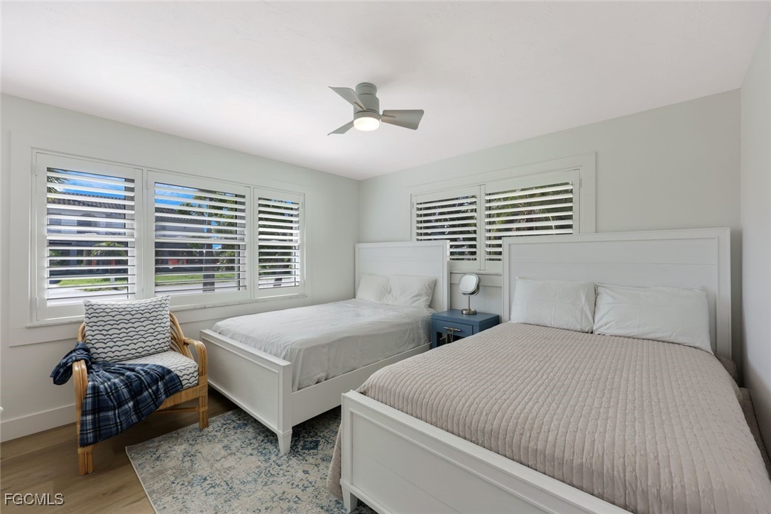 707 Durion Court Sanibel, FL 33957 - Photo 18 of 31 a bedroom with two beds and a large window