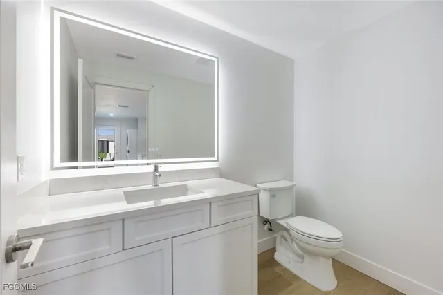 a view of a patio with a table and chairs under an umbrella