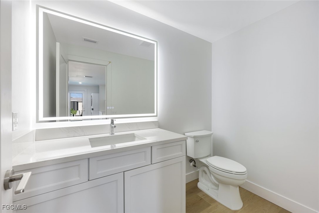 707 Durion Court Sanibel, FL 33957 - Photo 21 of 31 a bathroom with a sink a toilet and mirror