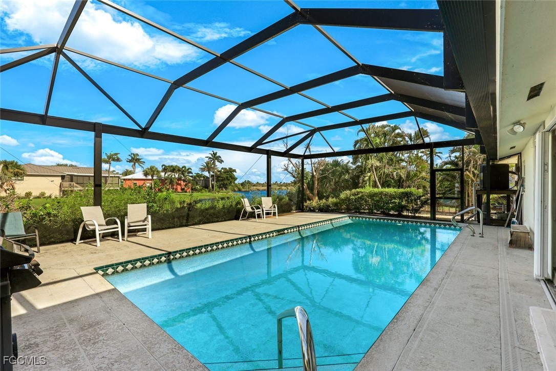 707 Durion Court Sanibel, FL 33957 - Photo 22 of 31 a view of a patio with a table and chairs under an umbrella
