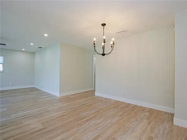 a view of a room with wooden floor and white walls
