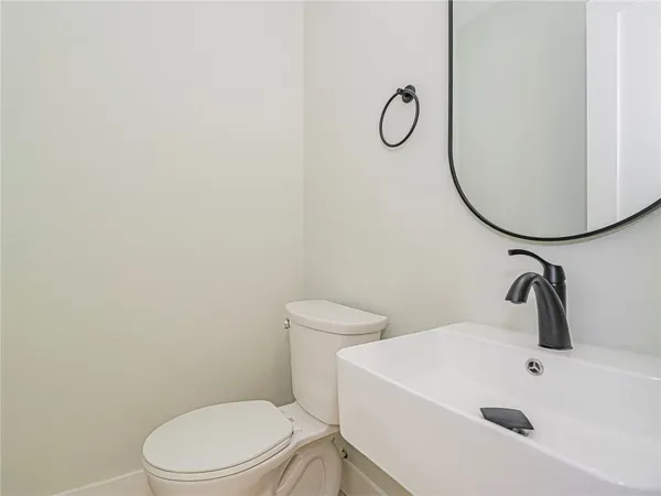 a white toilet sitting next to a bathroom sink
