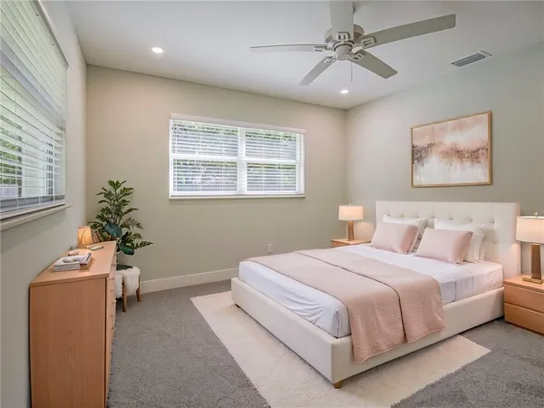 a bedroom with a large bed and a window