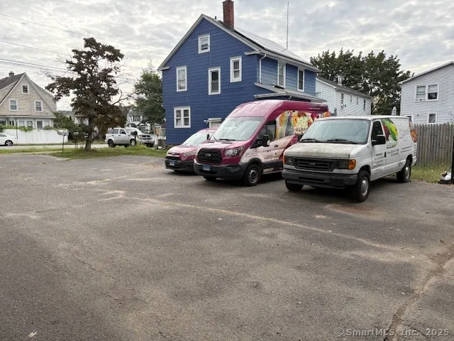 a couple of cars parked in front of a house