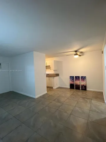 a view of a livingroom with furniture and a ceiling fan