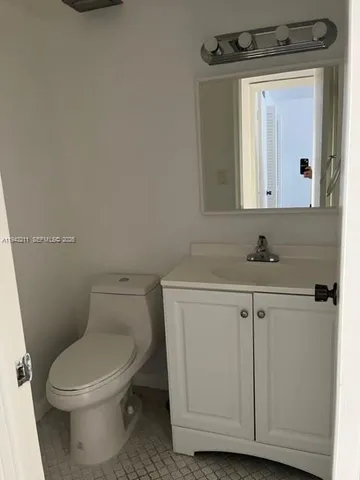 a white toilet sitting next to a bathroom sink