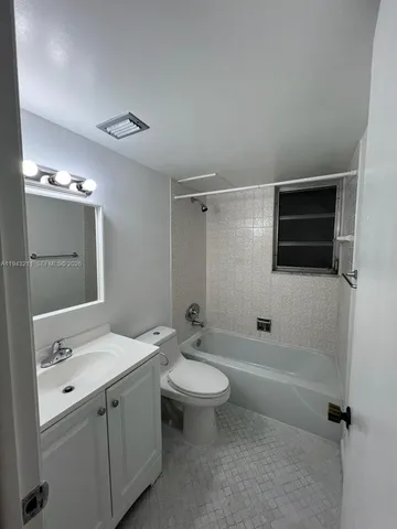 a bathroom with a double vanity sink toilet mirror and shower