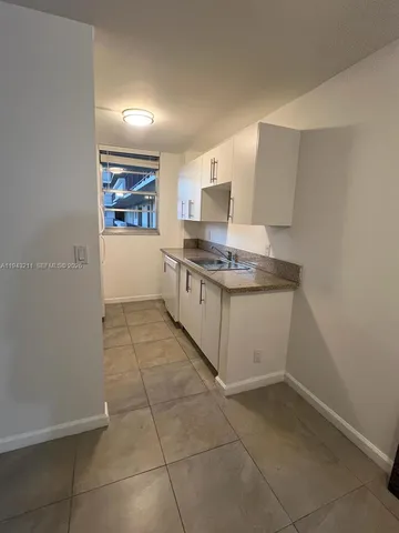 a kitchen with stainless steel appliances a sink stove and cabinets