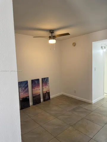 a view of an empty room with a fan