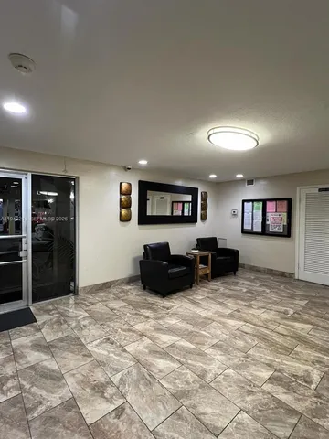 an empty room with furniture and a flat screen tv